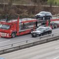 Автовоз із легковими автомобілями на трасі