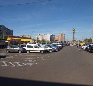 Сірі, білі й чорні авто на парковці торговельного центру в Києві